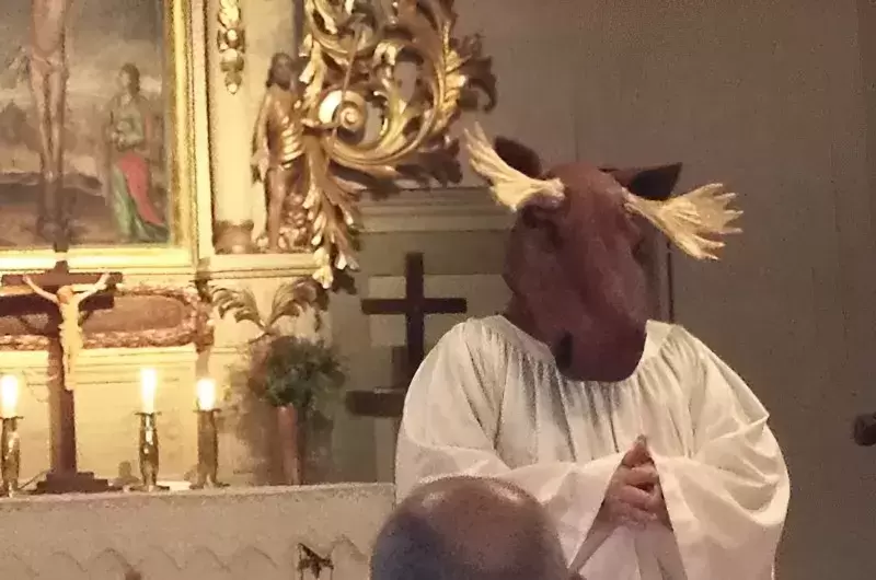 Swedish female Priest wearing a plush Elk head when preaching
